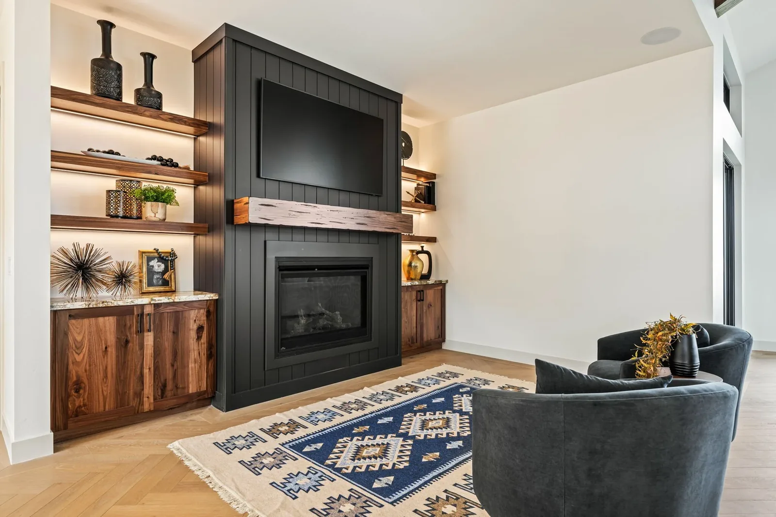 Built-in entertainment center with walnut cabinetry and floating shelves